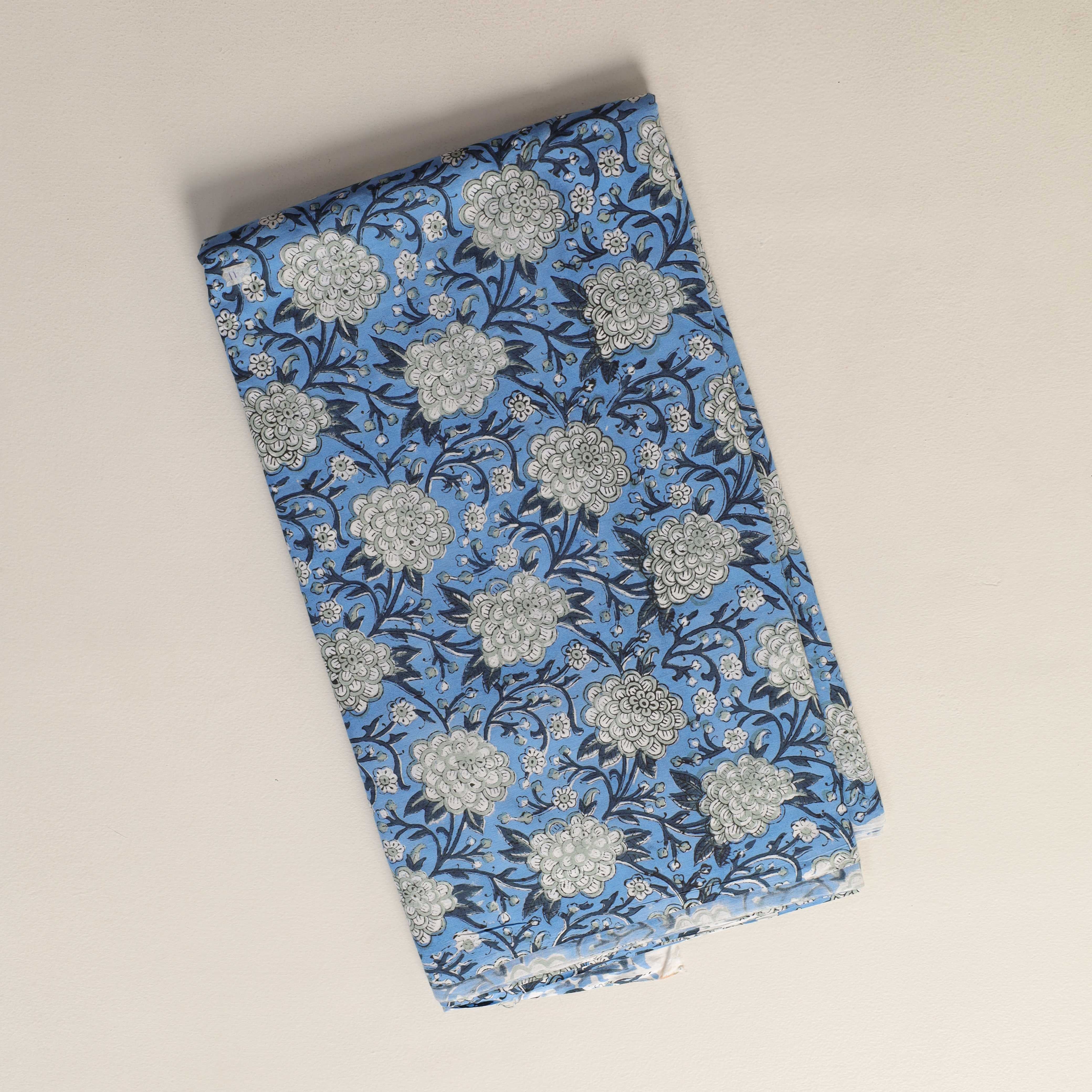 Folded fabric with floral pattern on a beige background