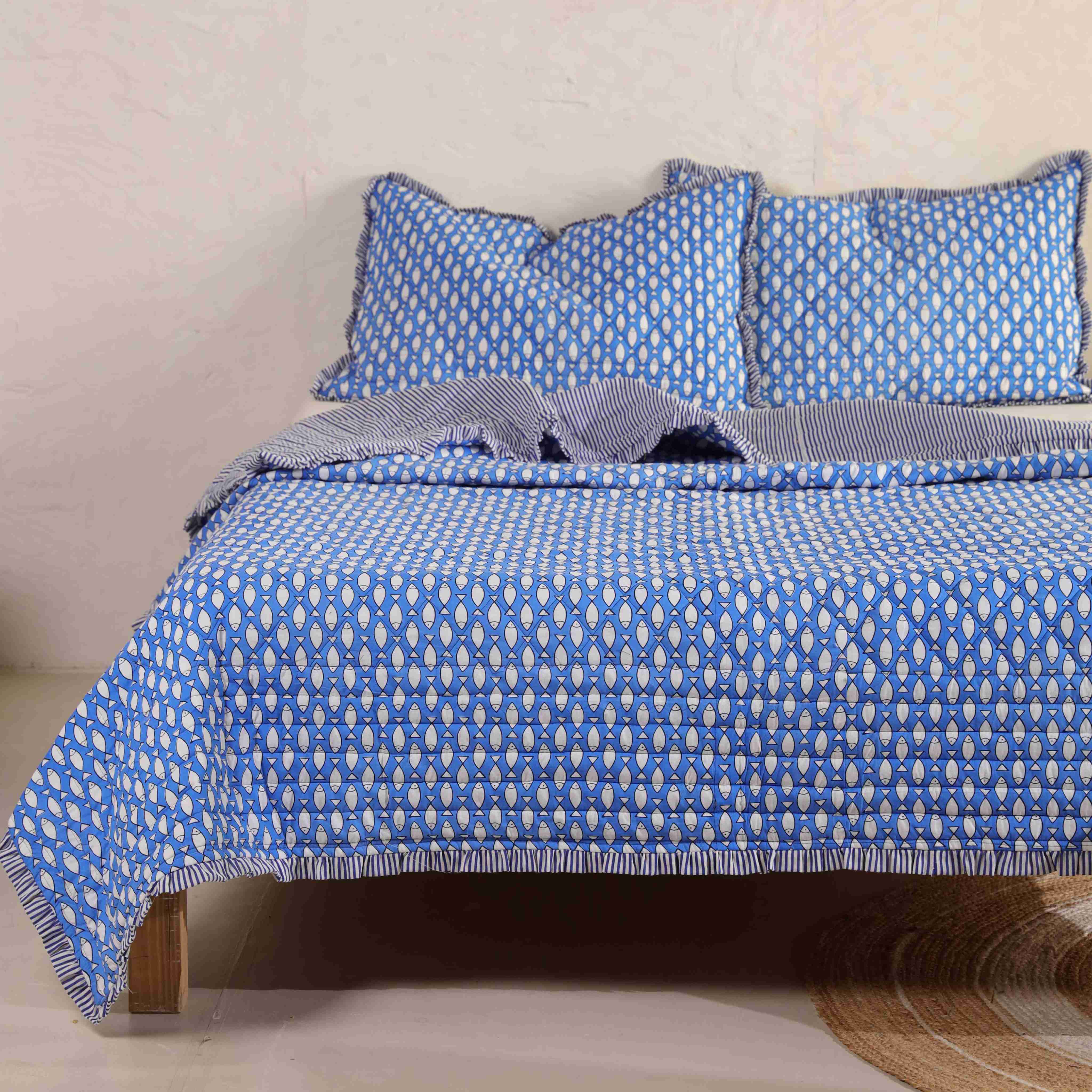 Close-up of the white geometric print on the soft azure blue velvet fabric.
