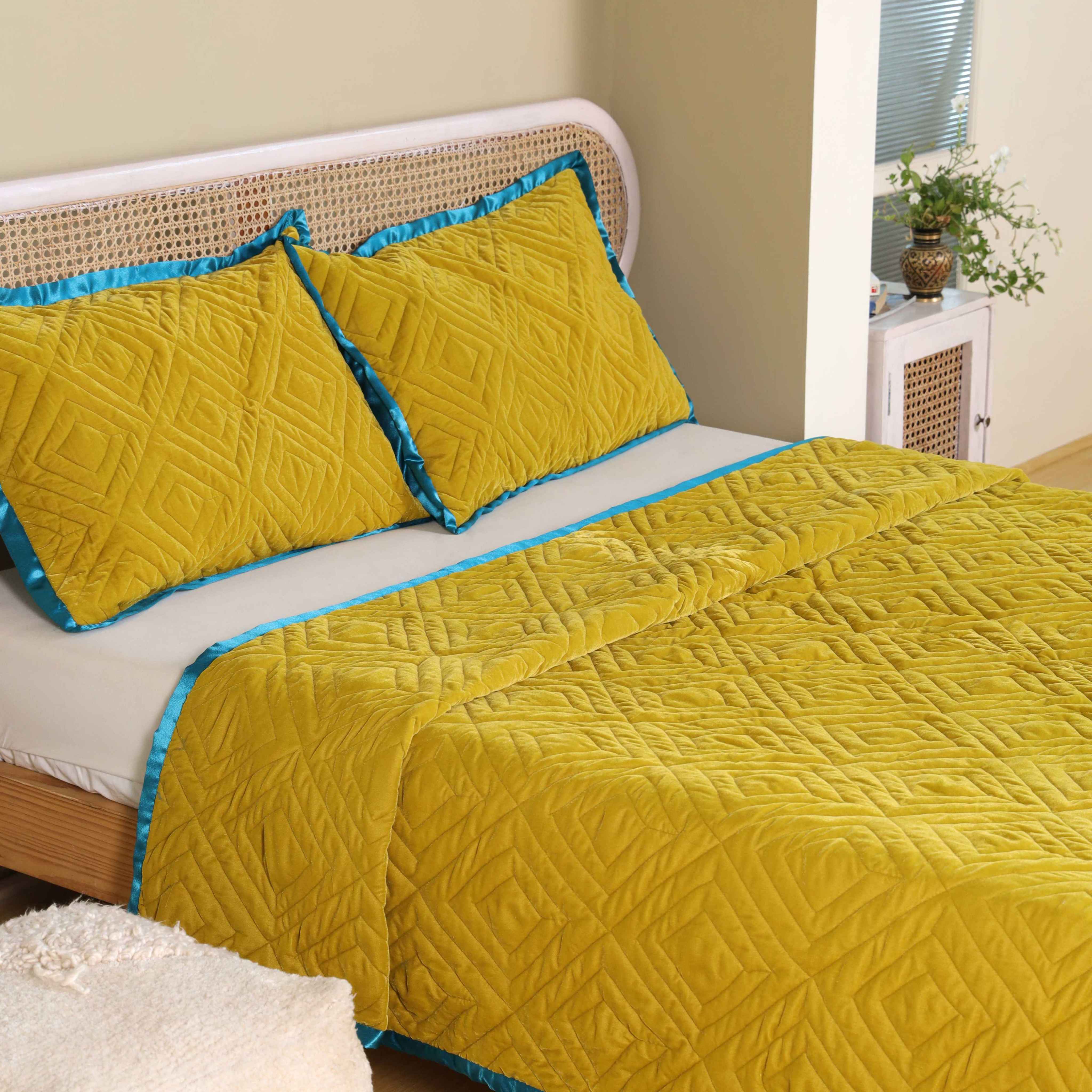 Detailed shot of the quilted diamond pattern on premium mustard yellow satin fabric.