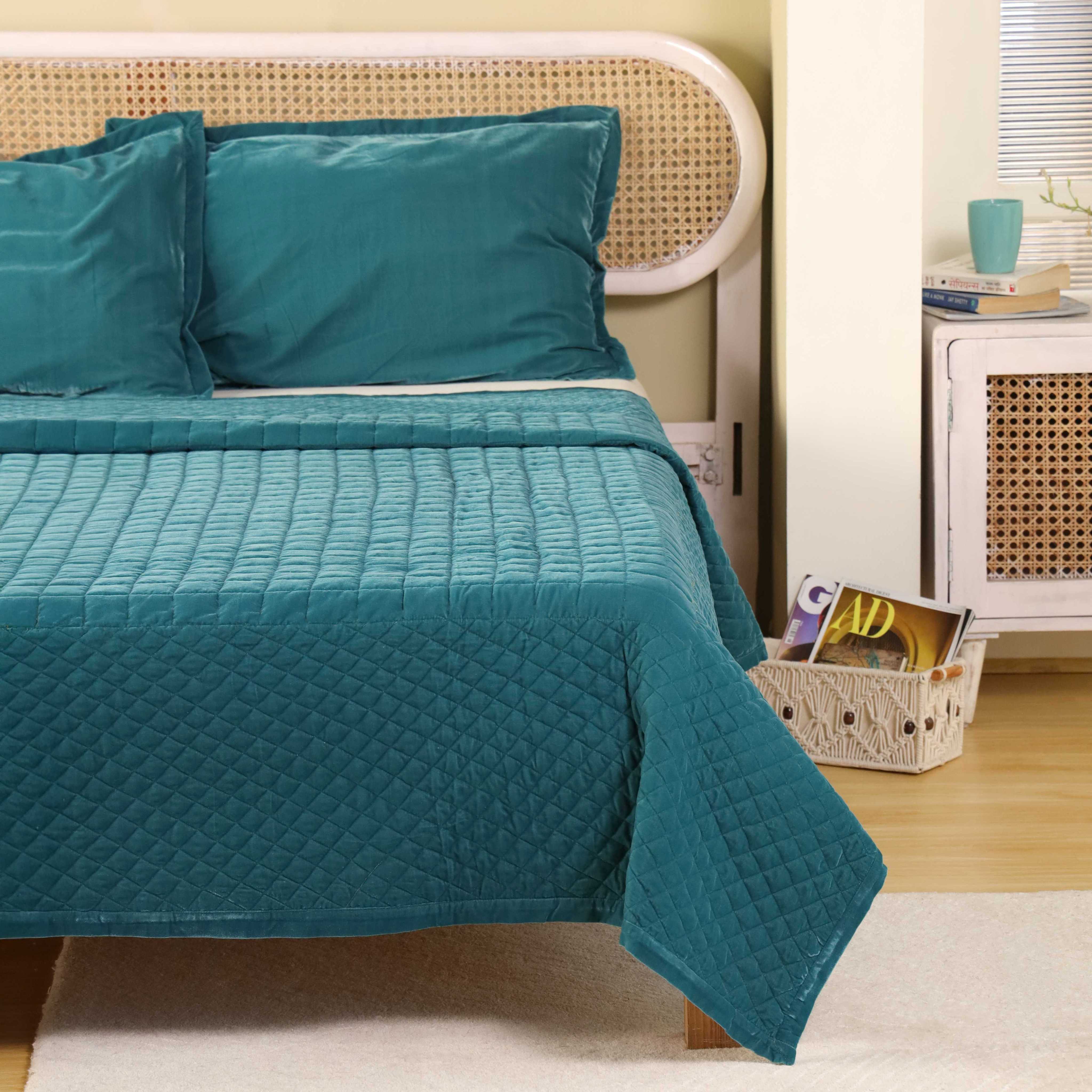 Macro shot of the plush teal velvet fabric showing the soft pile and quilted texture.