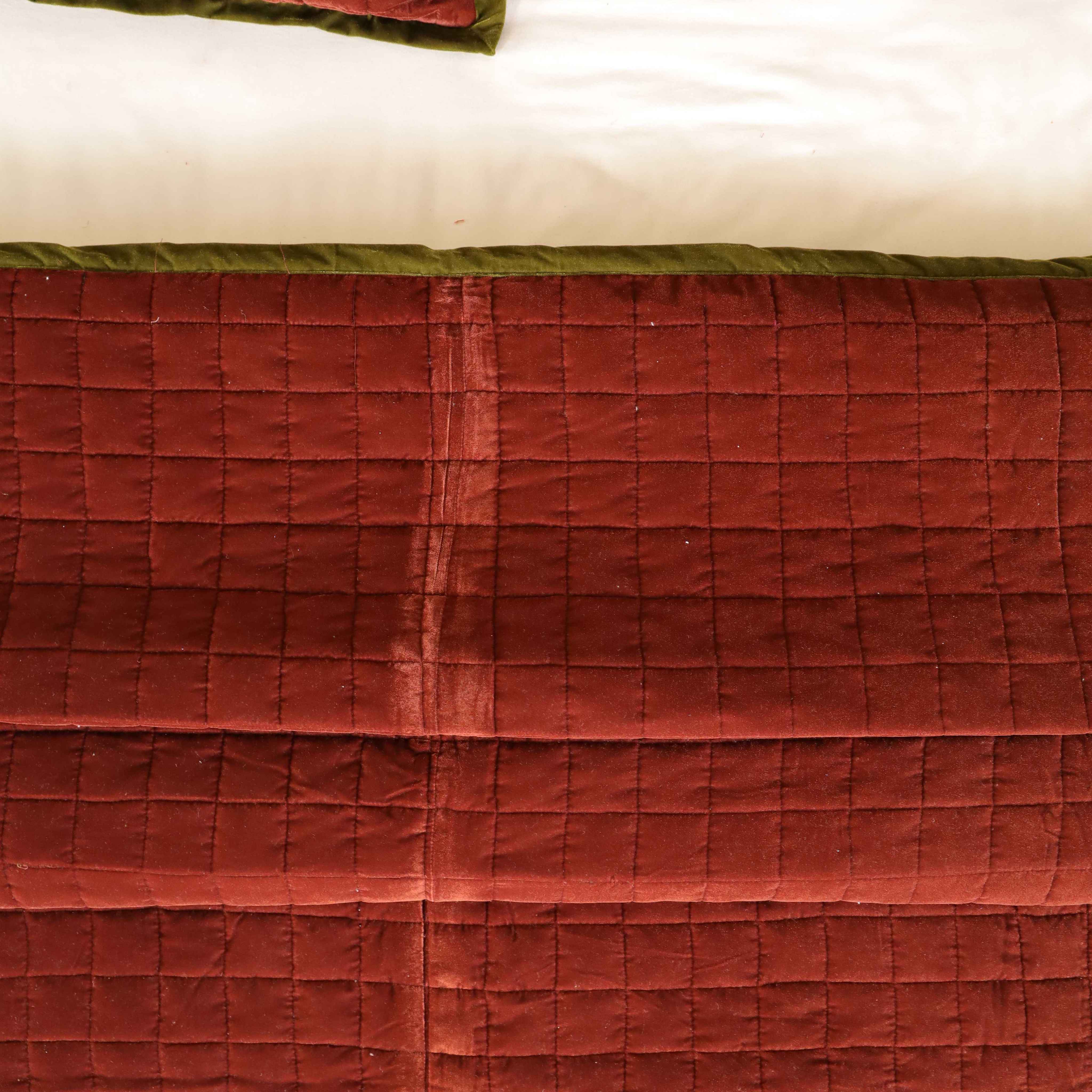 Lifestyle view of a cozy bedroom featuring a maroon velvet duvet and boho-style accessories.