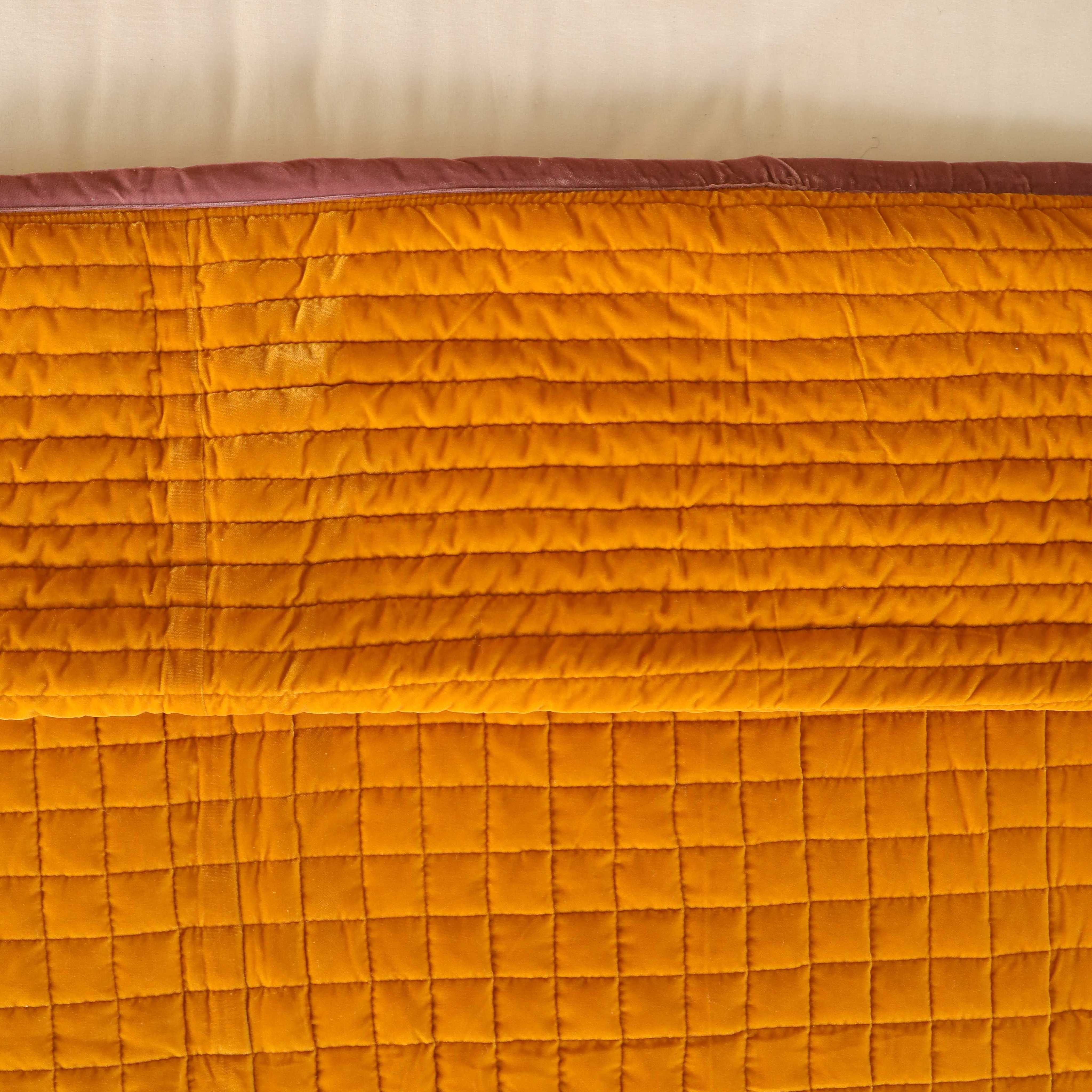 High-angle lifestyle view of a cozy bedroom featuring a mustard yellow and mauve velvet duvet set.