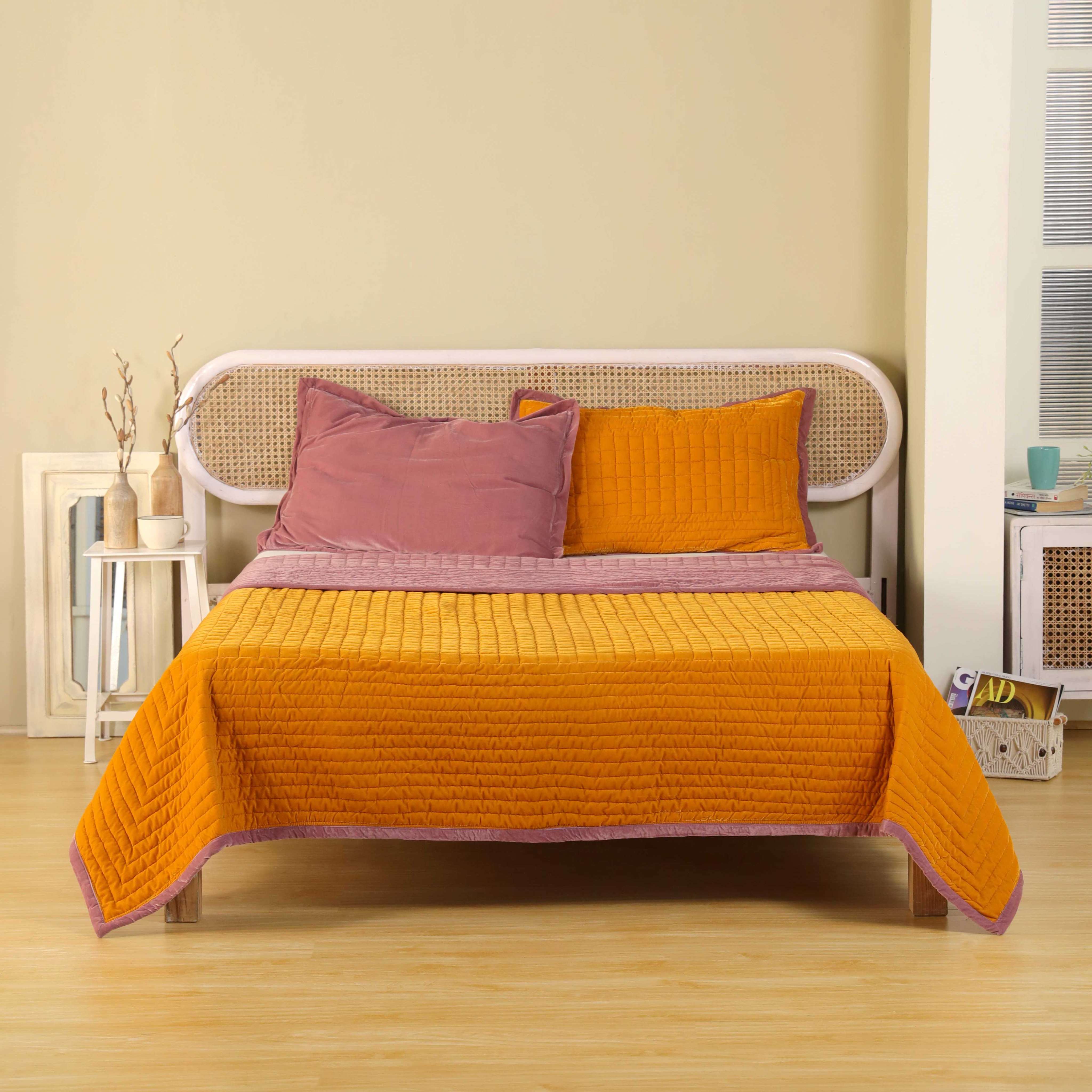 Reversible velvet duvet cover in mustard yellow and dusty pink with horizontal channel quilting.