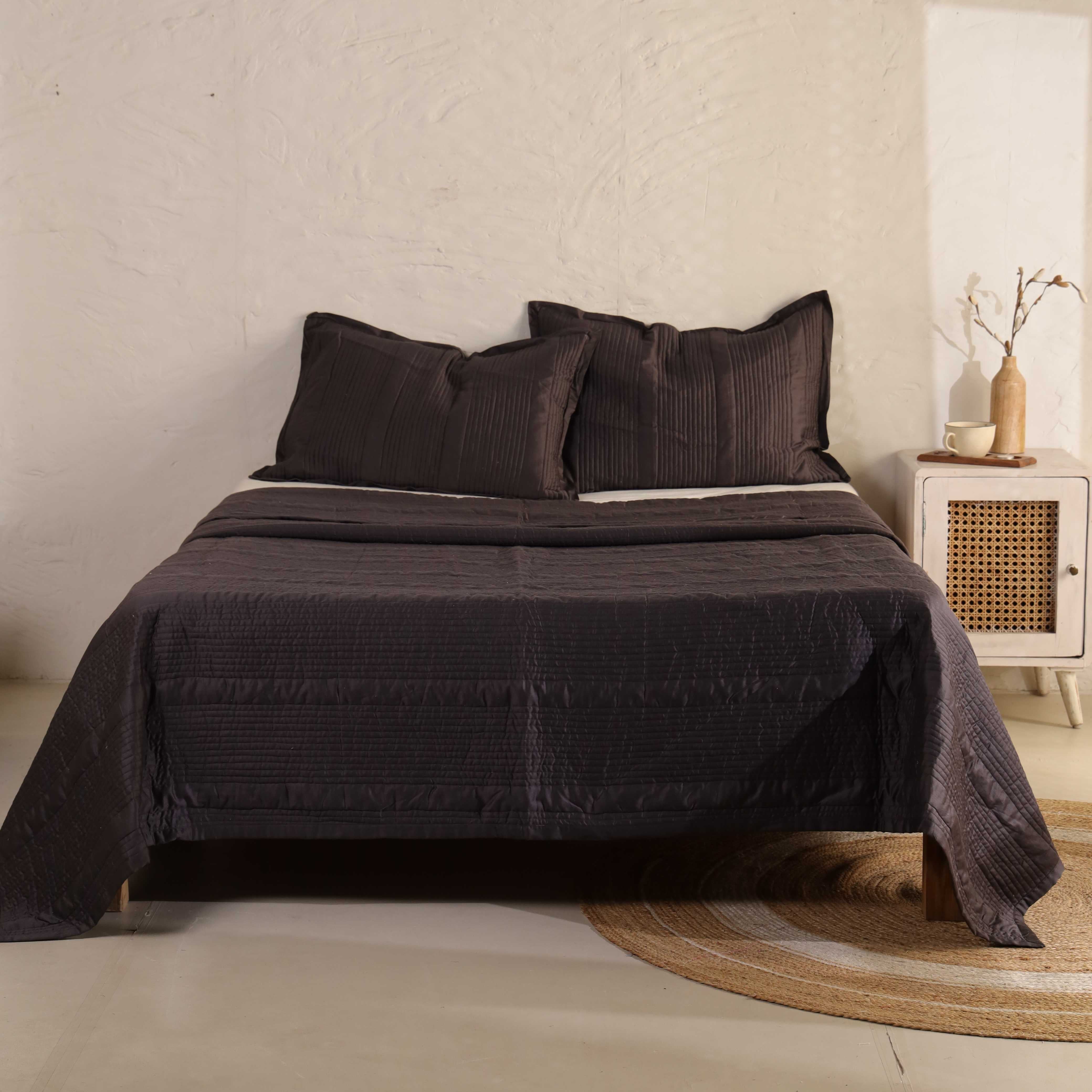 3-piece rich coffee brown velvet quilt set with matching pillows on a bed.