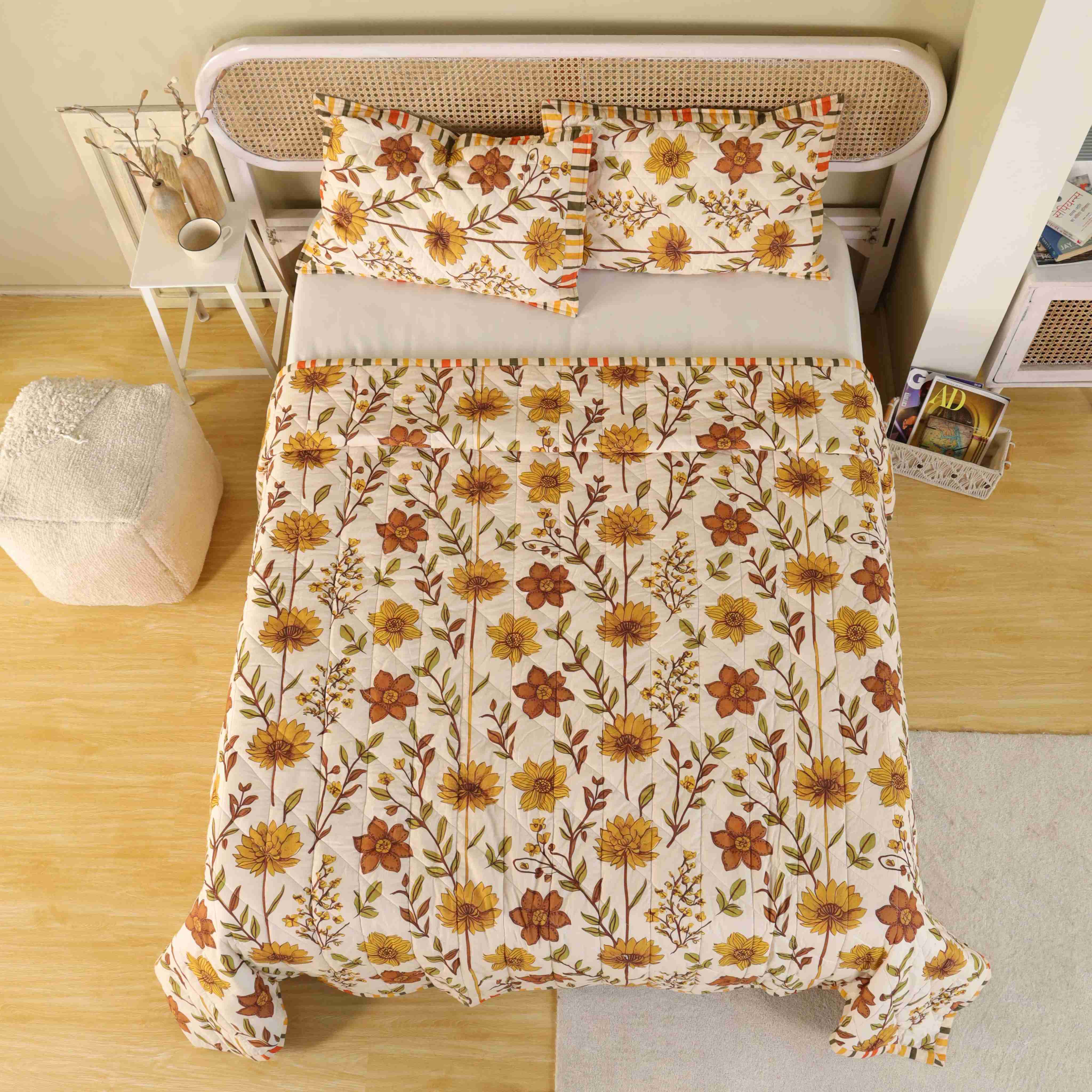 Two matching beige floral pillow covers with striped edge detailing.