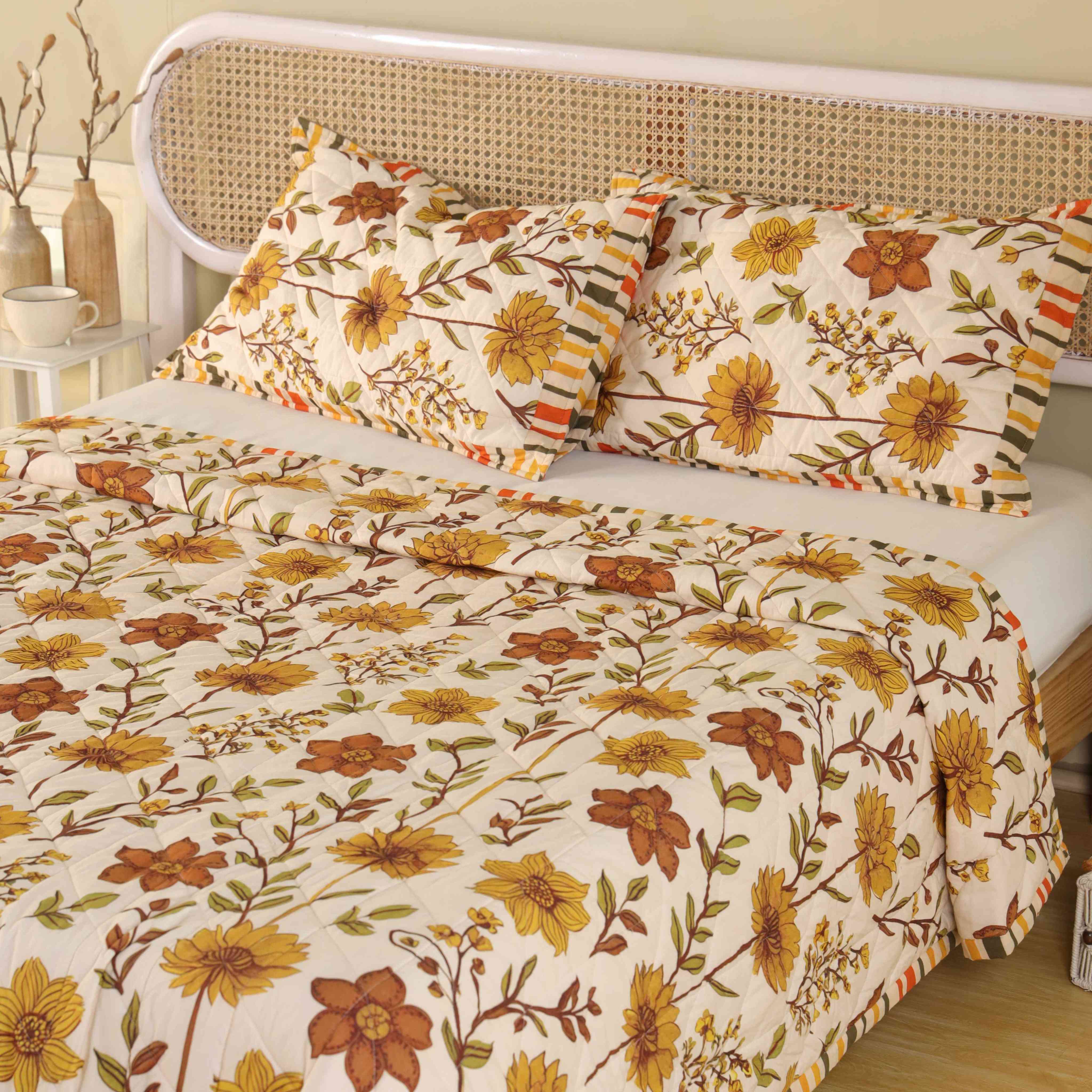 Close-up of olive and rust floral patterns on a beige cotton fabric.