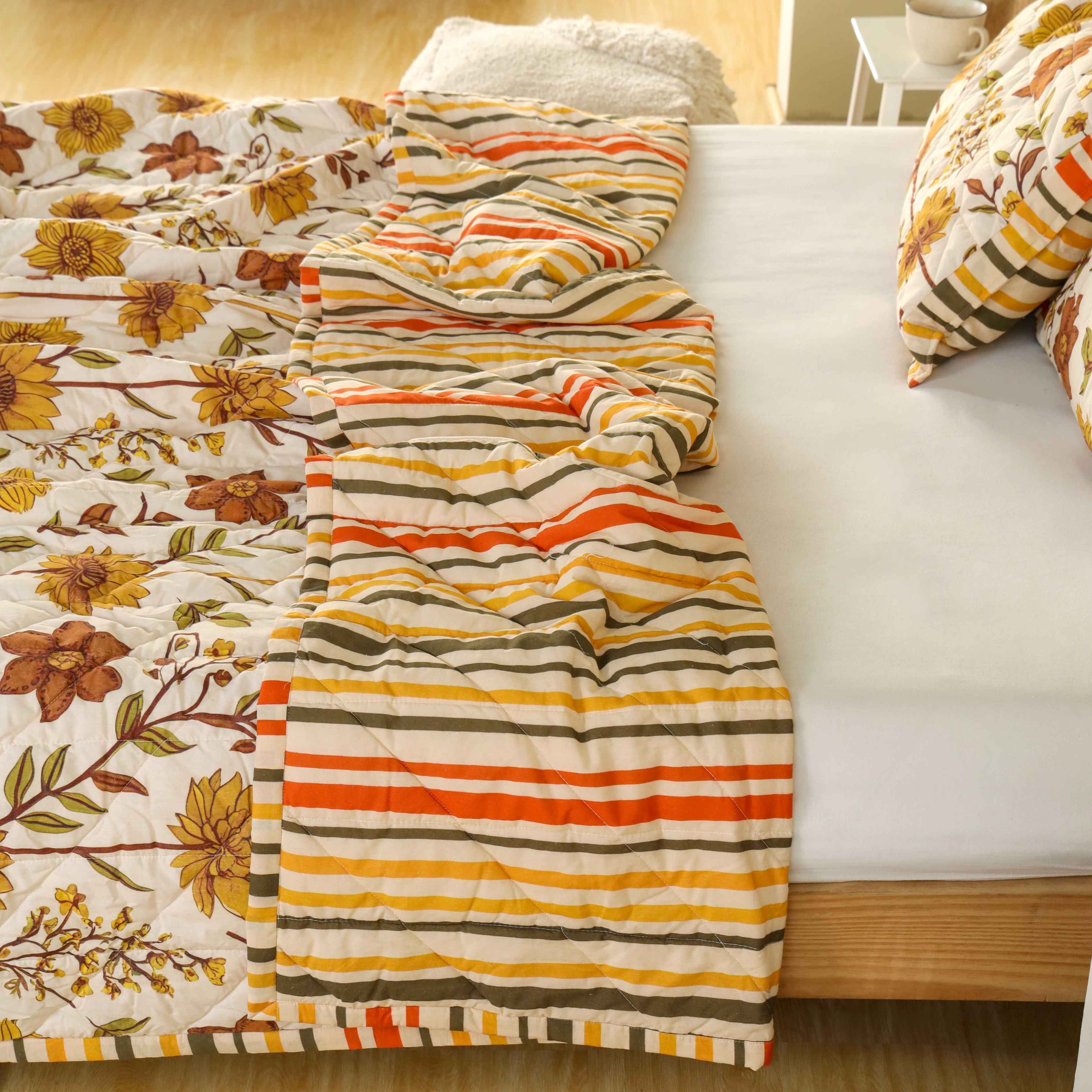 Close-up of olive and rust floral patterns on a beige cotton fabric.