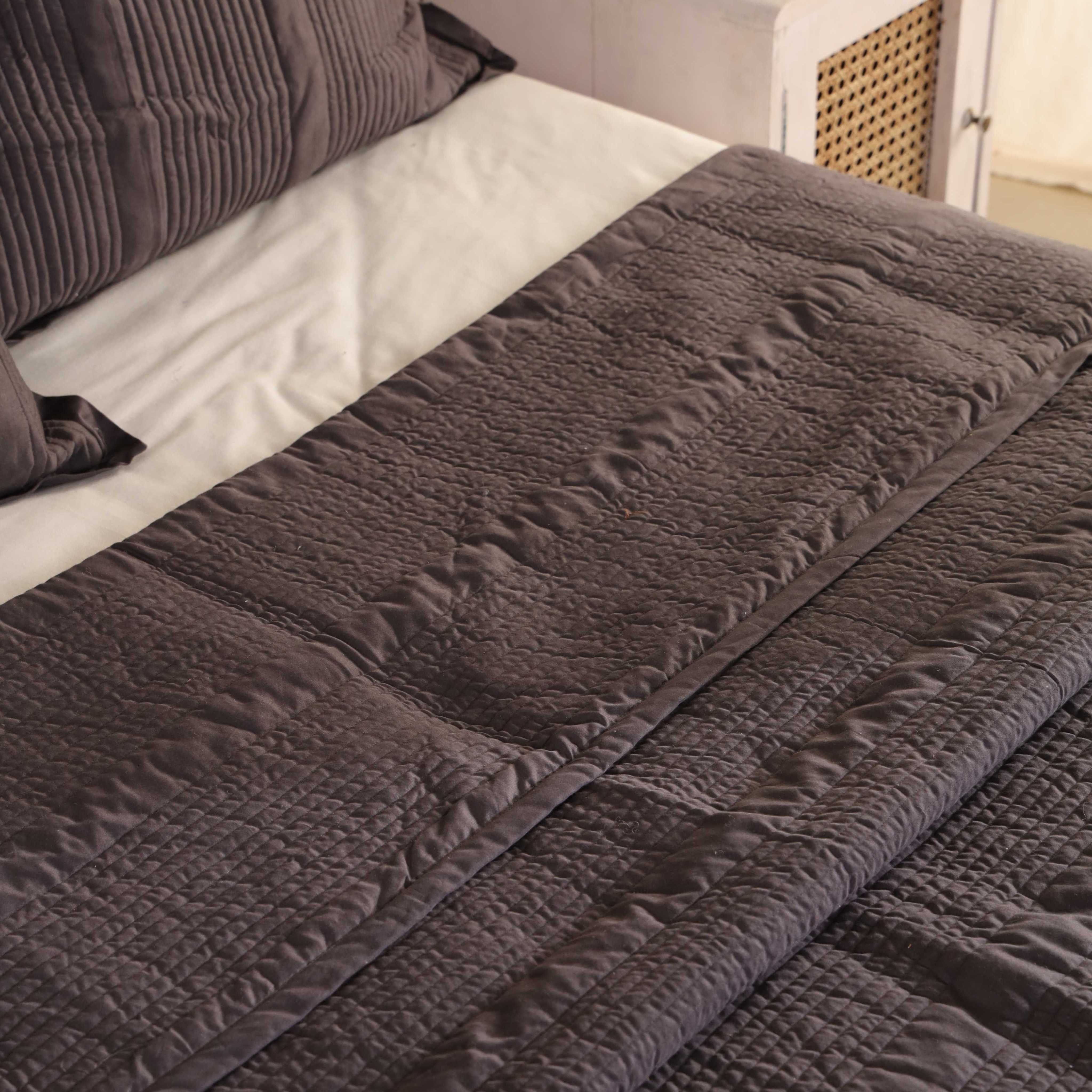 Close-up of the horizontal channel quilting on soft coffee brown velvet fabric.