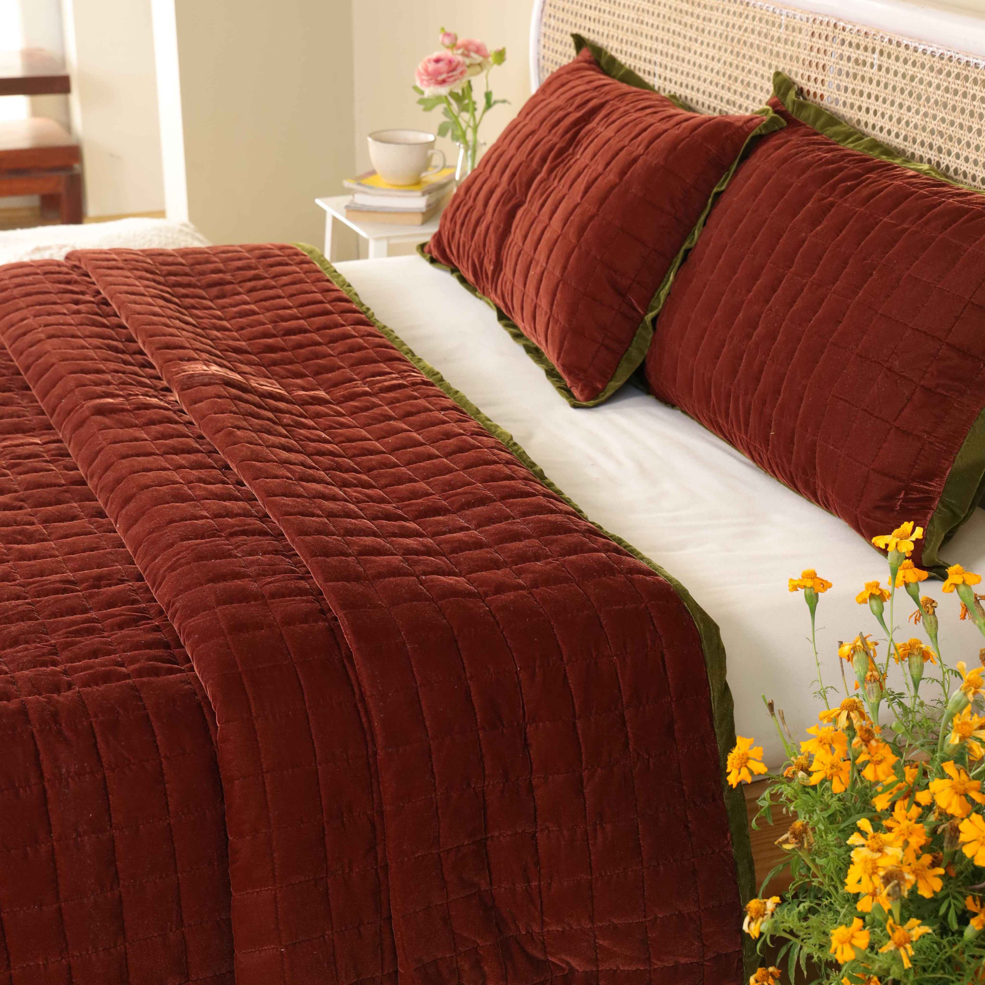 Detailed view of soft velvet fabric texture and square quilted stitching on a luxury duvet.