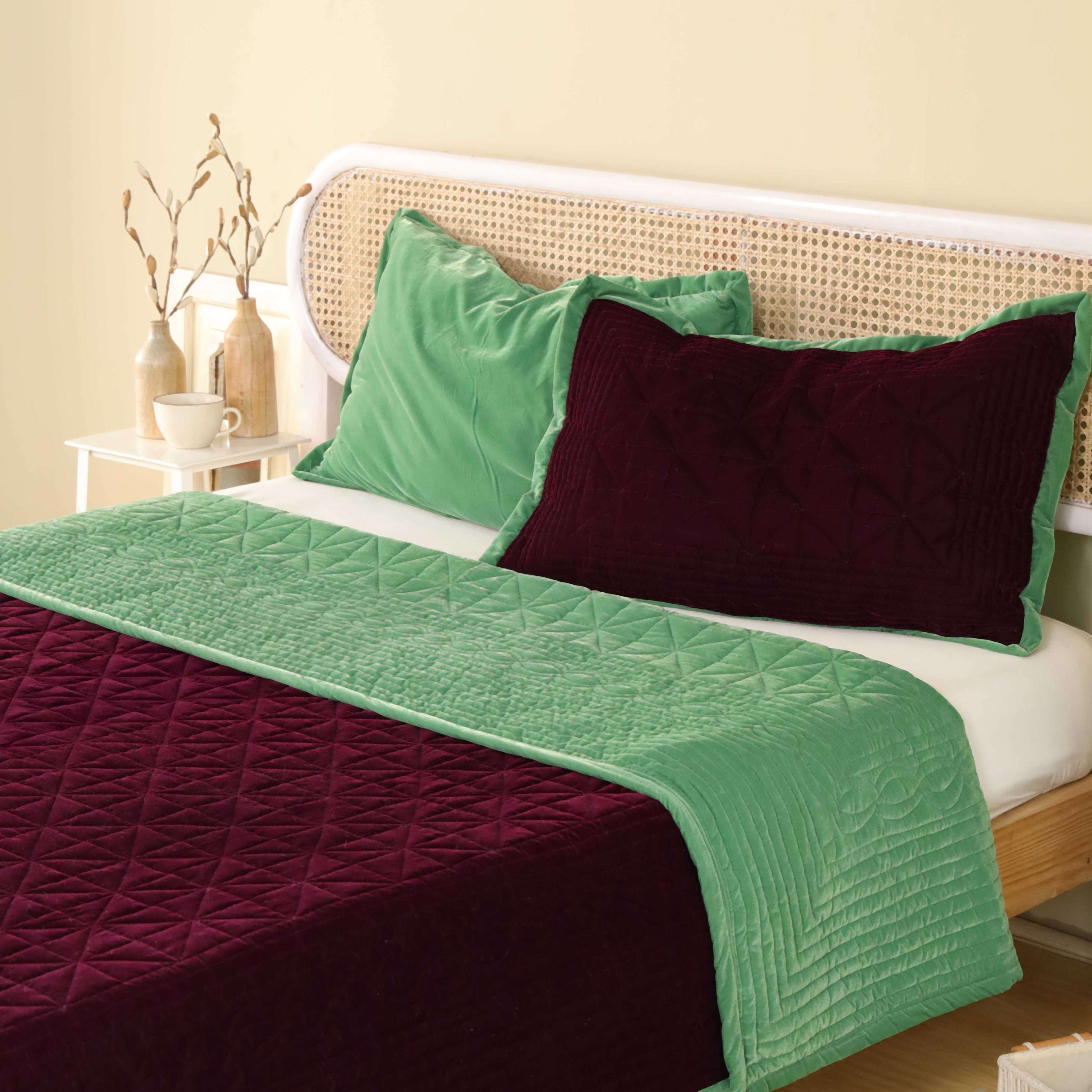 Detailed shot of the quilted diamond pattern on velvet and smooth satin fabric.