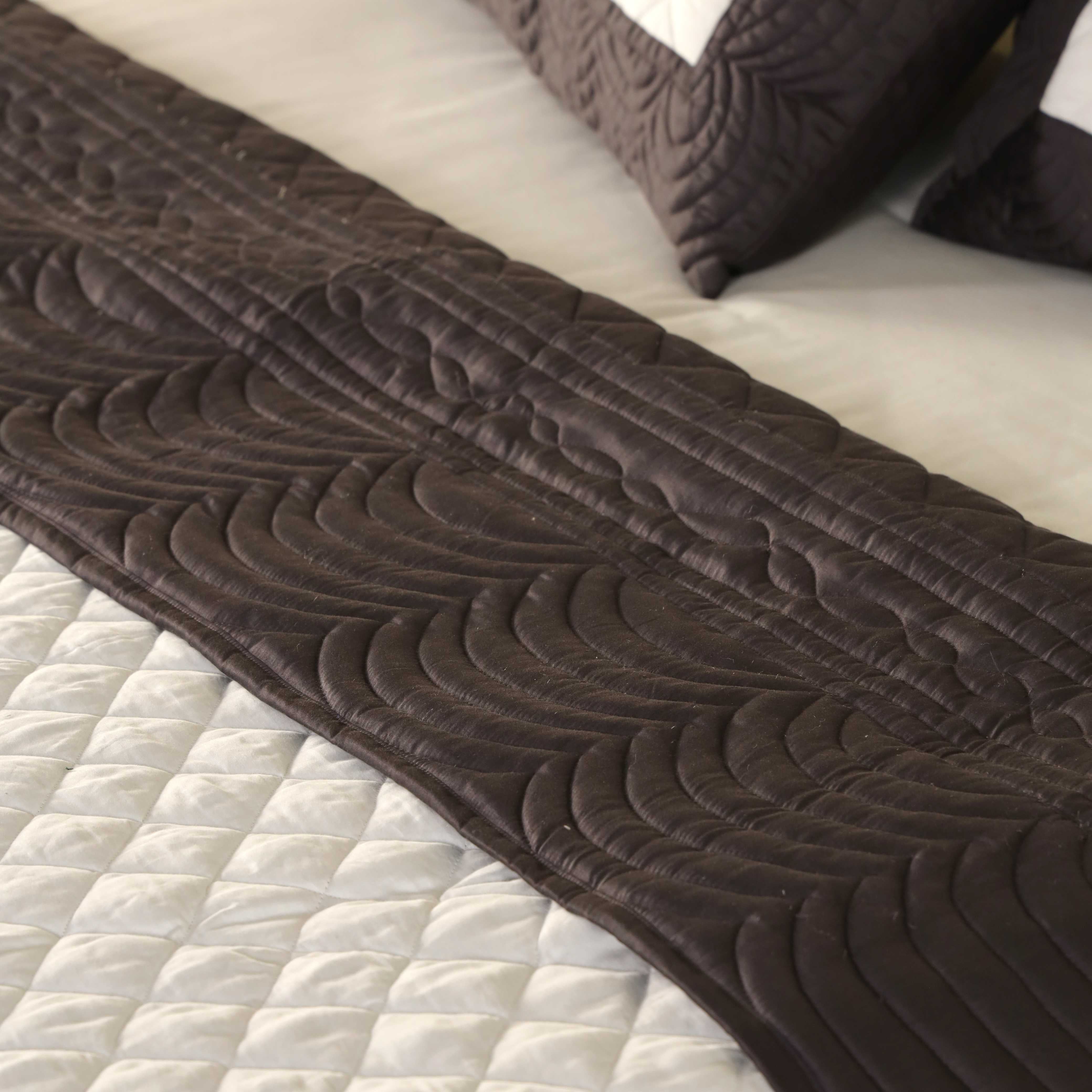 Two satin pillow covers with a white quilted center and chocolate brown border.