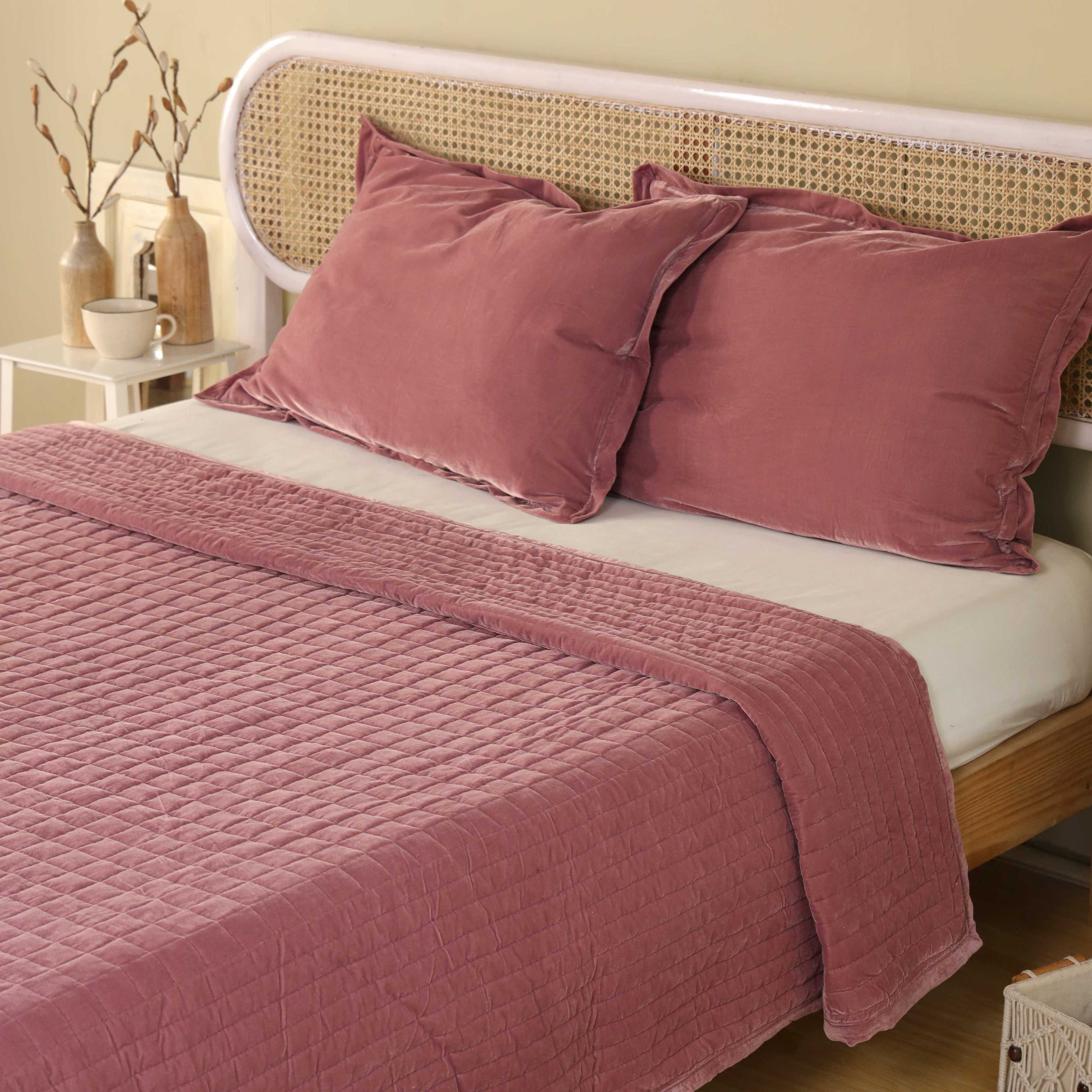 Matching dusty pink velvet pillow covers featuring soft quilting and a premium finish.