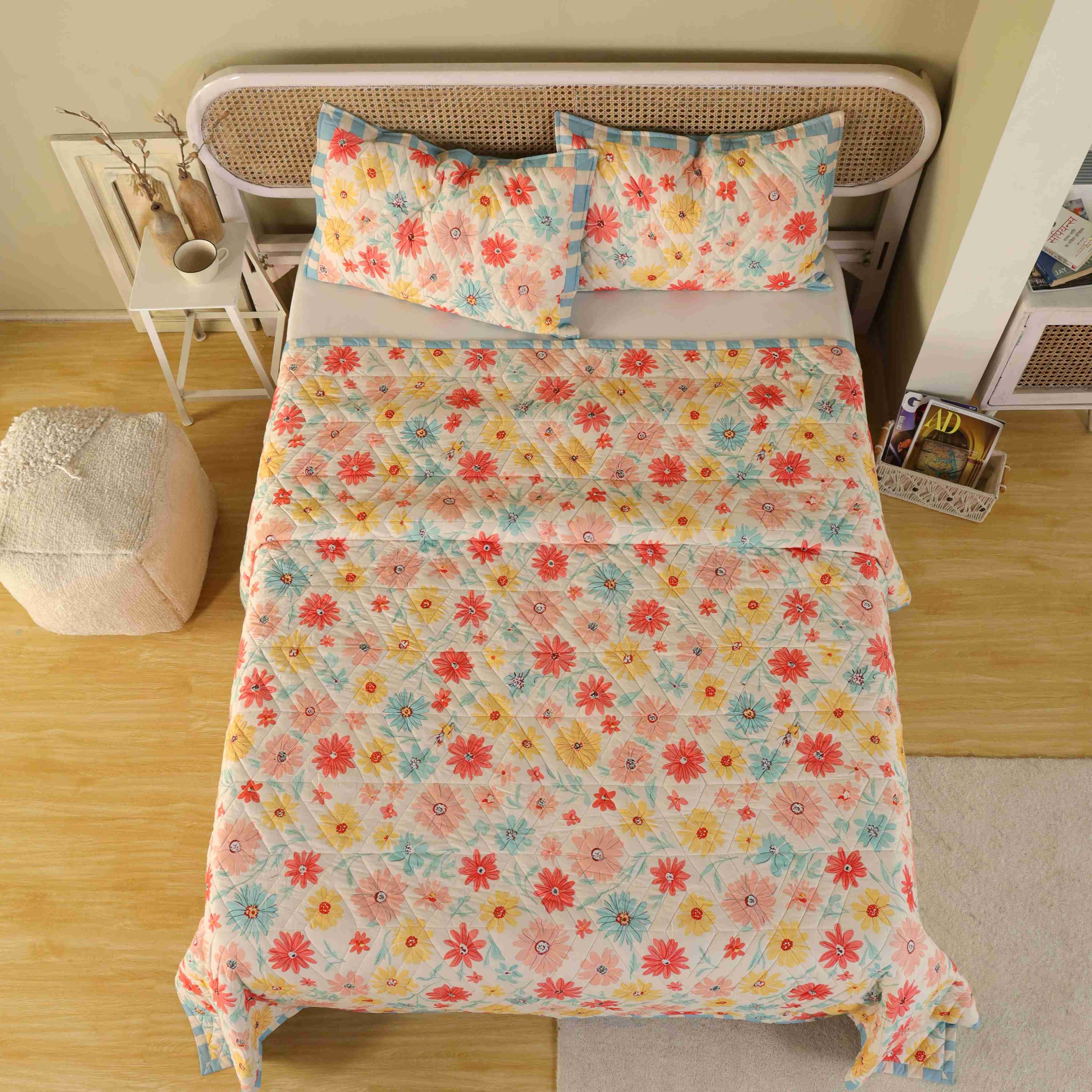 A neatly folded multi-color floral cotton quilt set showing its plush texture and colors.