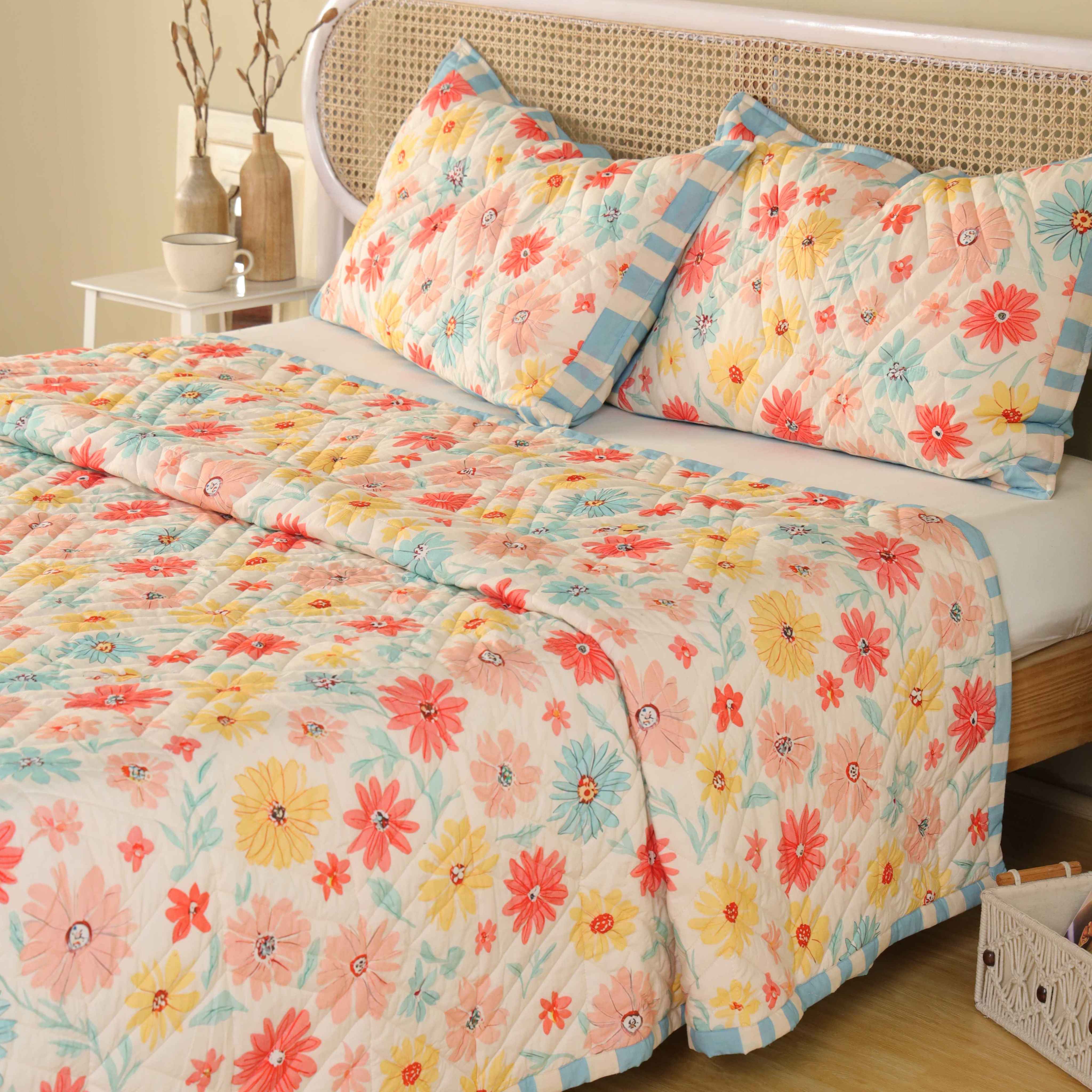 Maximalist bedroom interior featuring a vibrant multi-color floral cotton quilt.