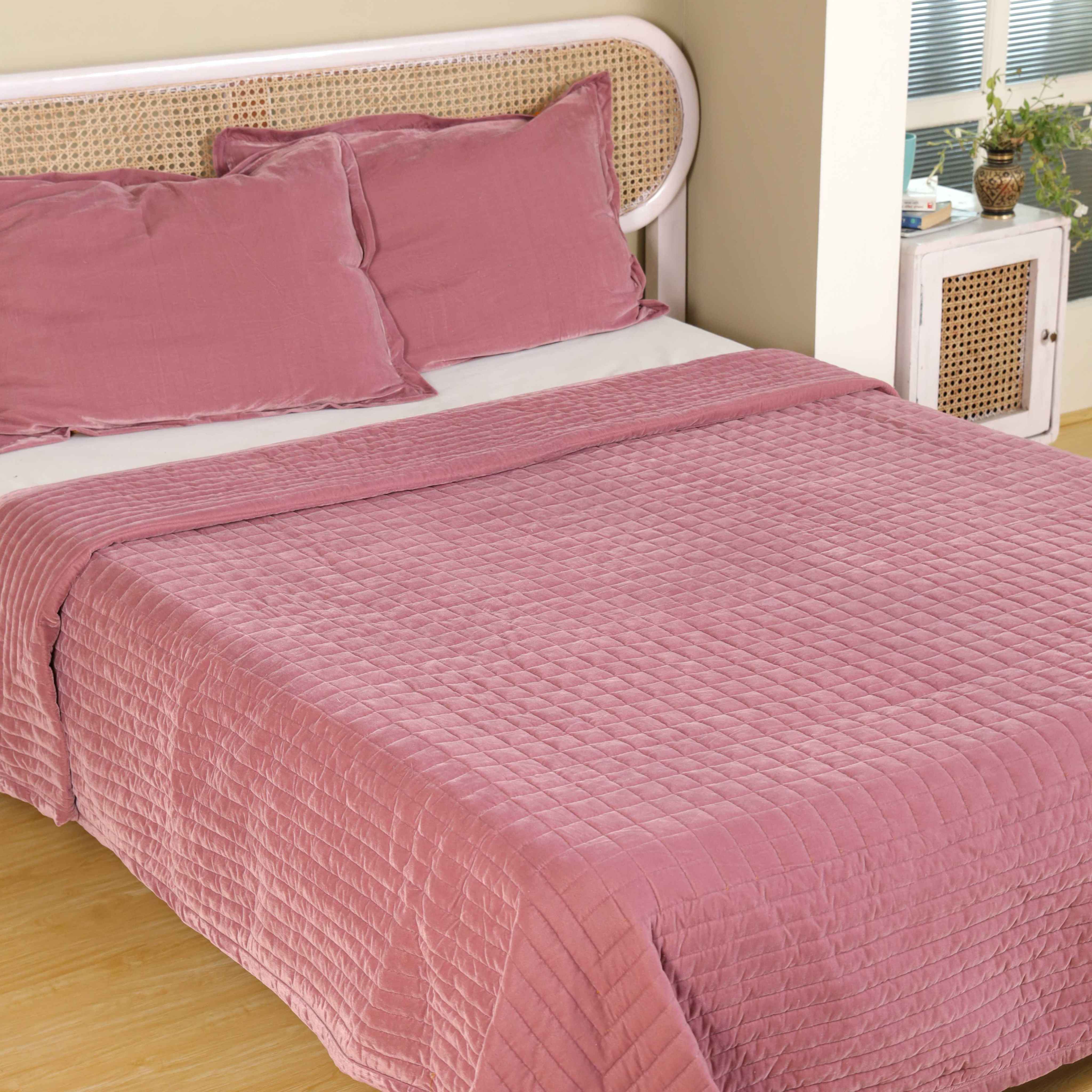 High-angle lifestyle shot of a cozy bedroom styled with a dusty pink velvet duvet set.