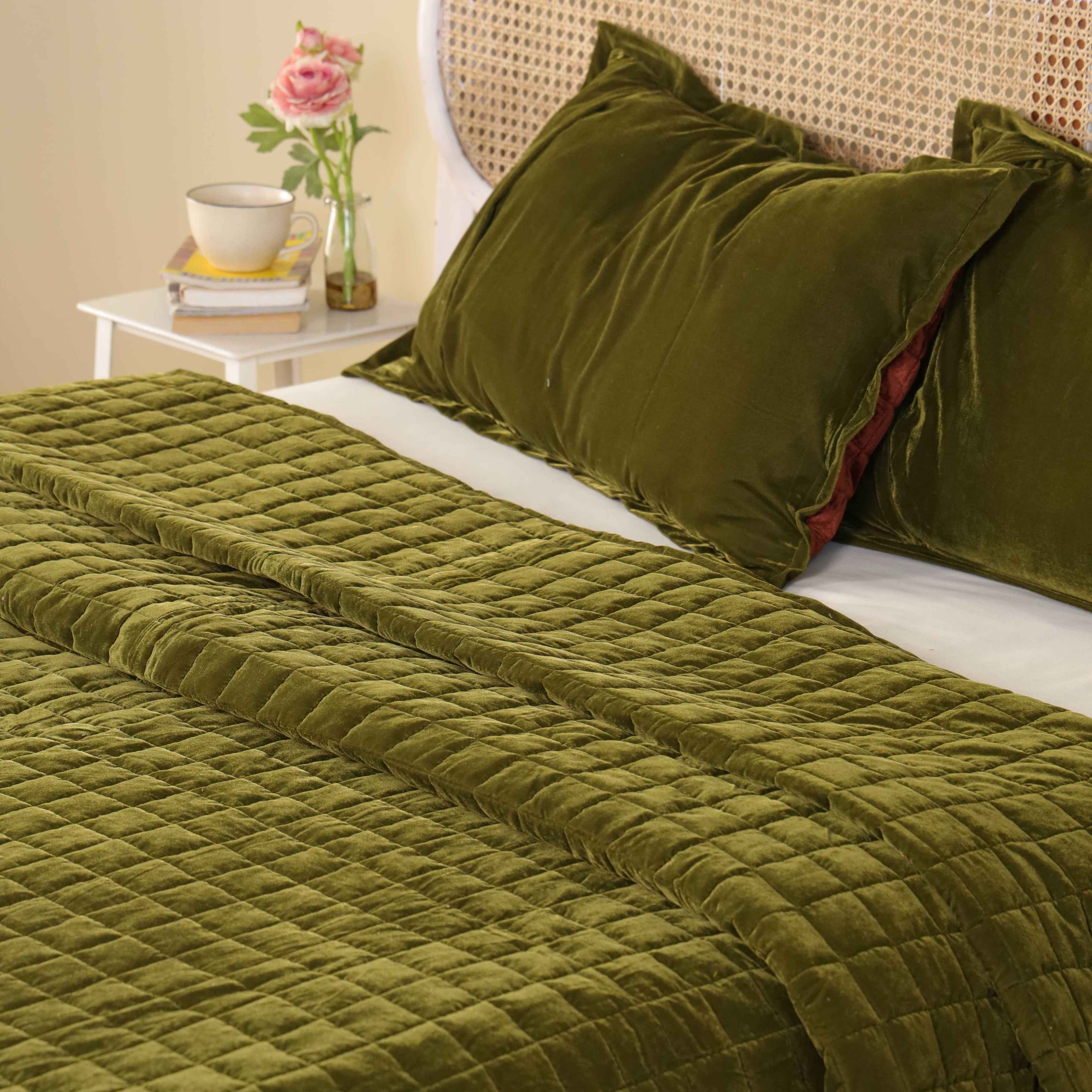 Luxury green velvet bedding featuring a modern square box quilted pattern and soft sheen.