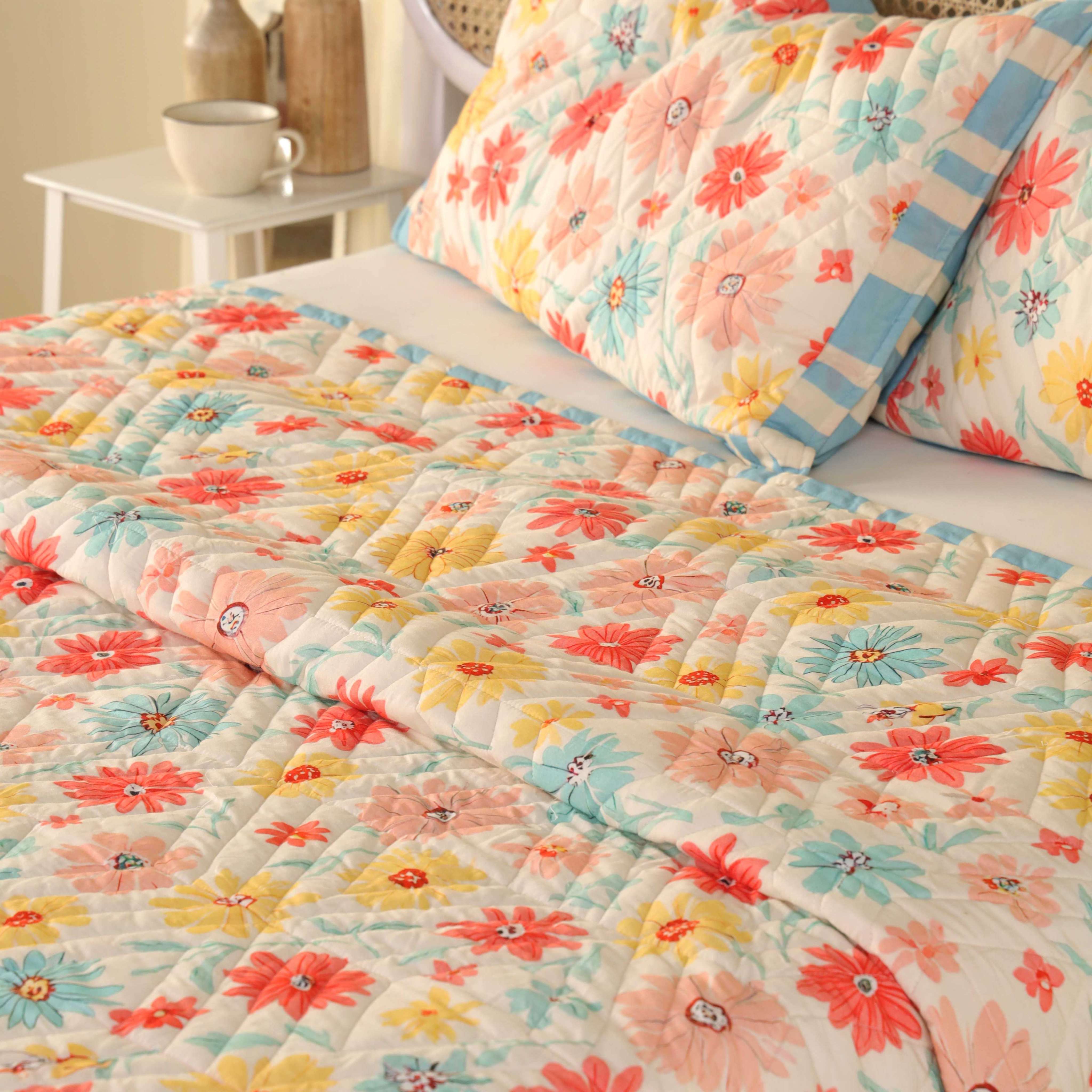 Close-up of the blue and white striped ruffle border on a wildflower cotton quilt.