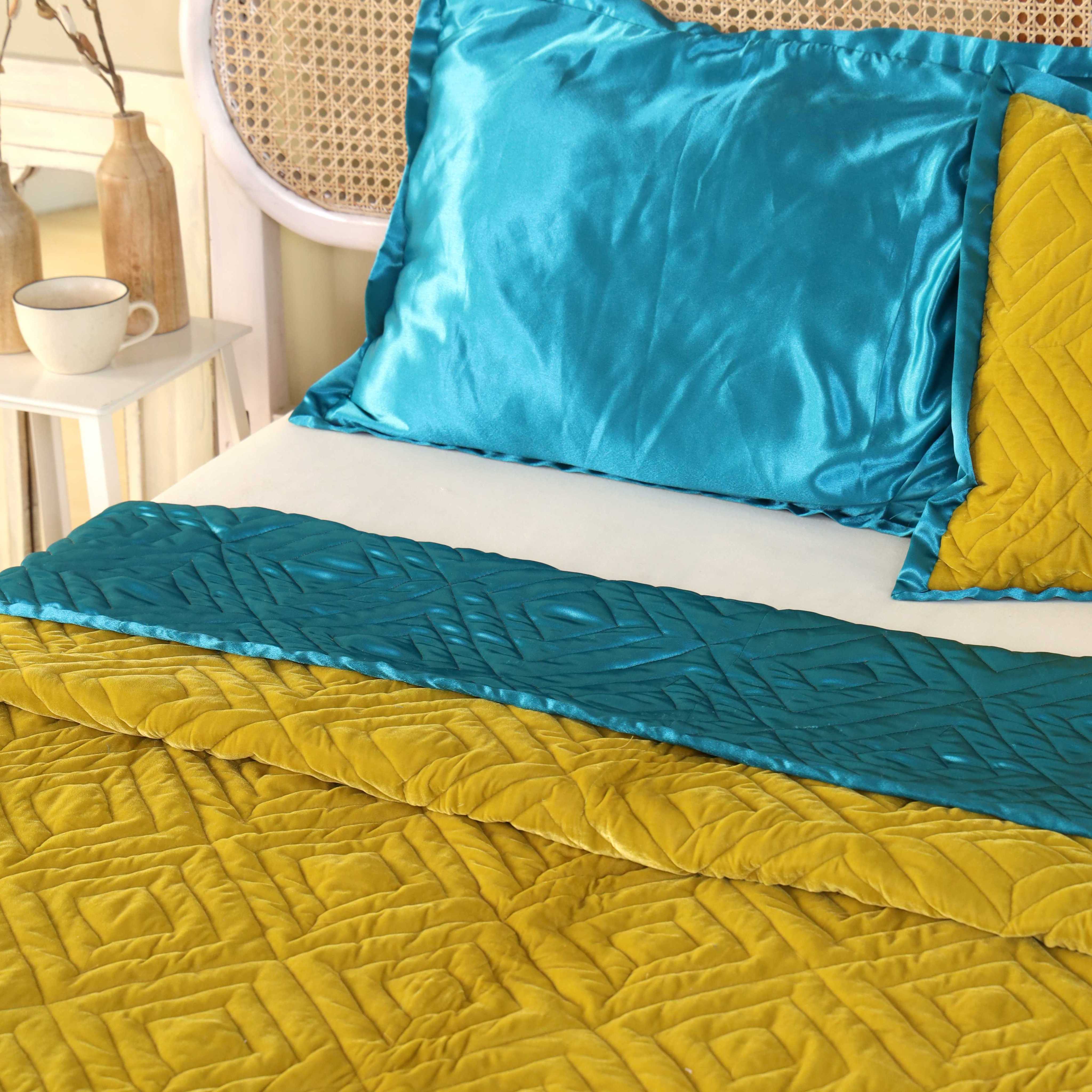 Close-up of the geometric diamond quilted texture on mustard yellow velvet.