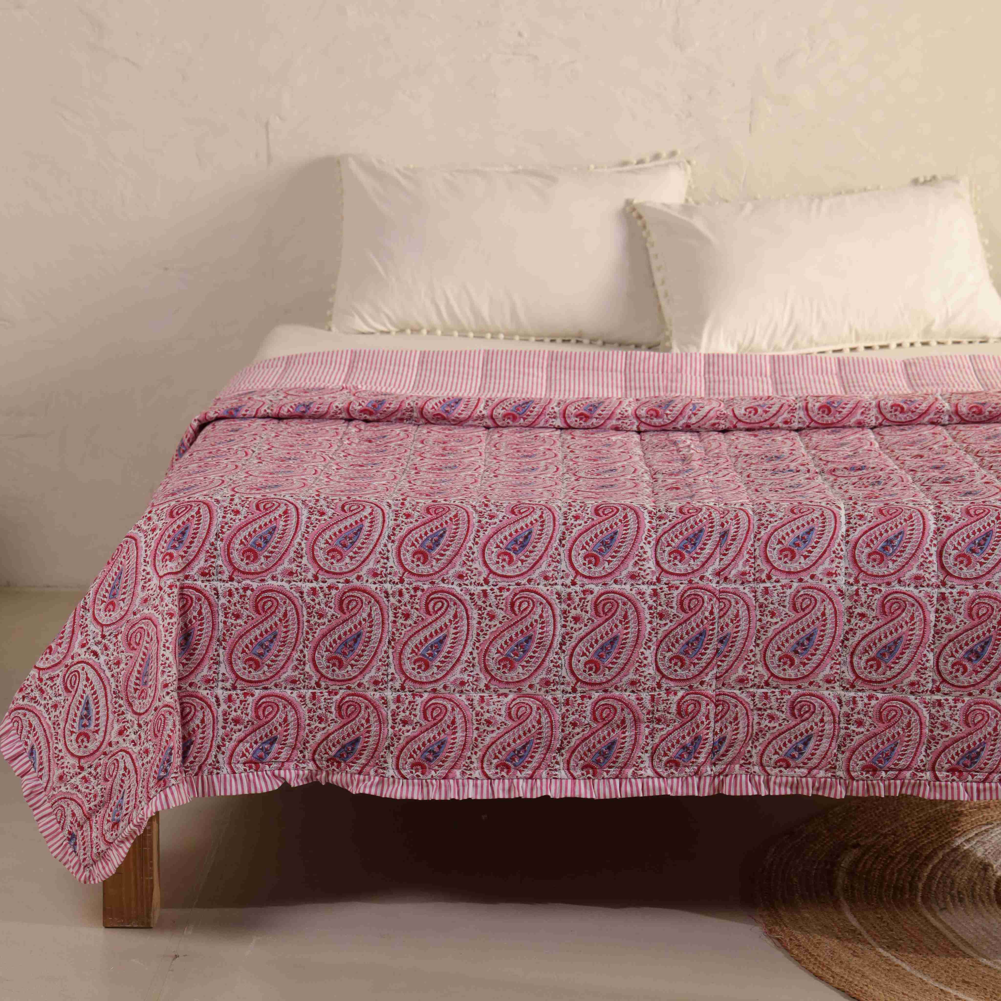 Close-up of the delicate pink botanical vine print and striped ruffle border.