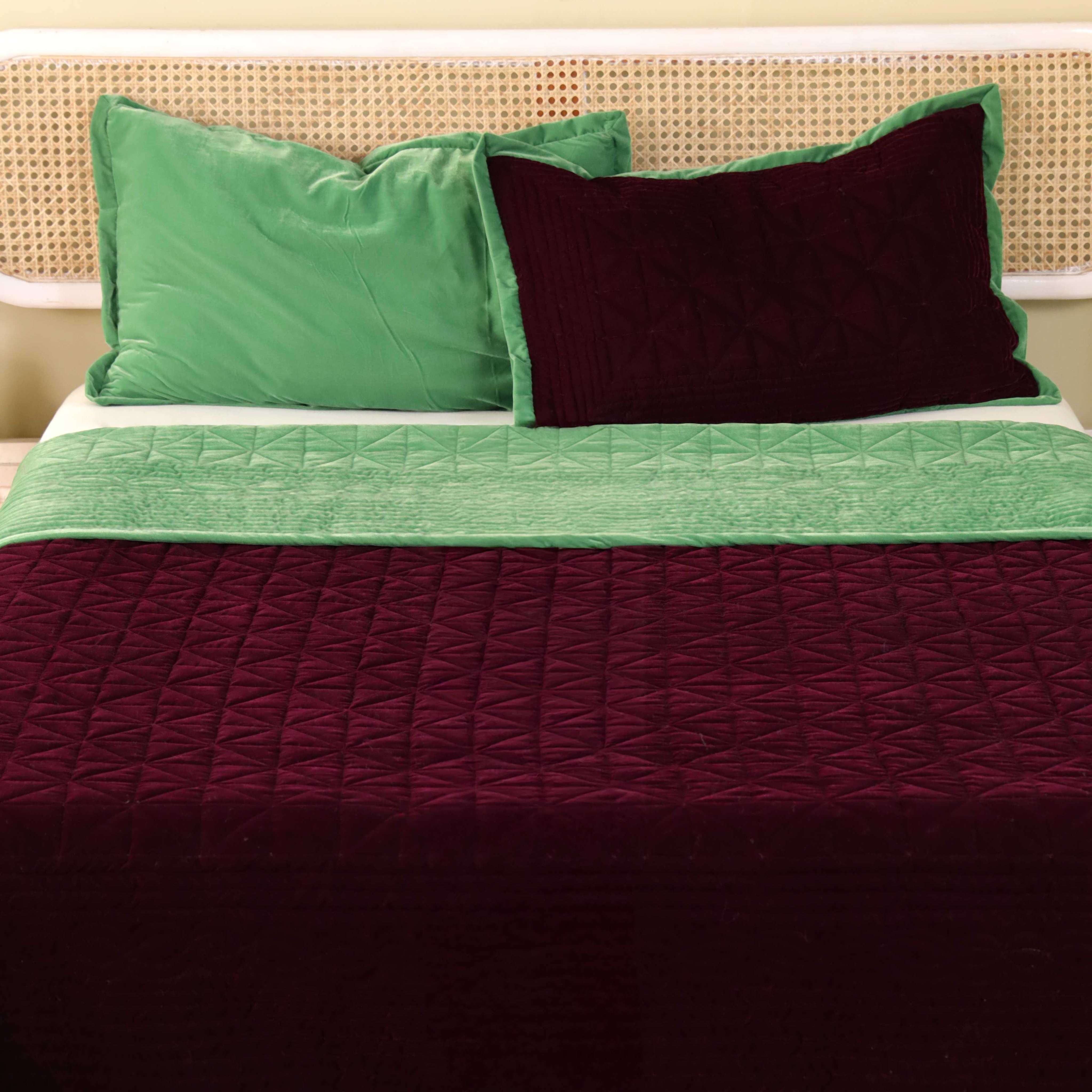 Close-up of reversible pillow covers showing velvet and satin material contrast.
