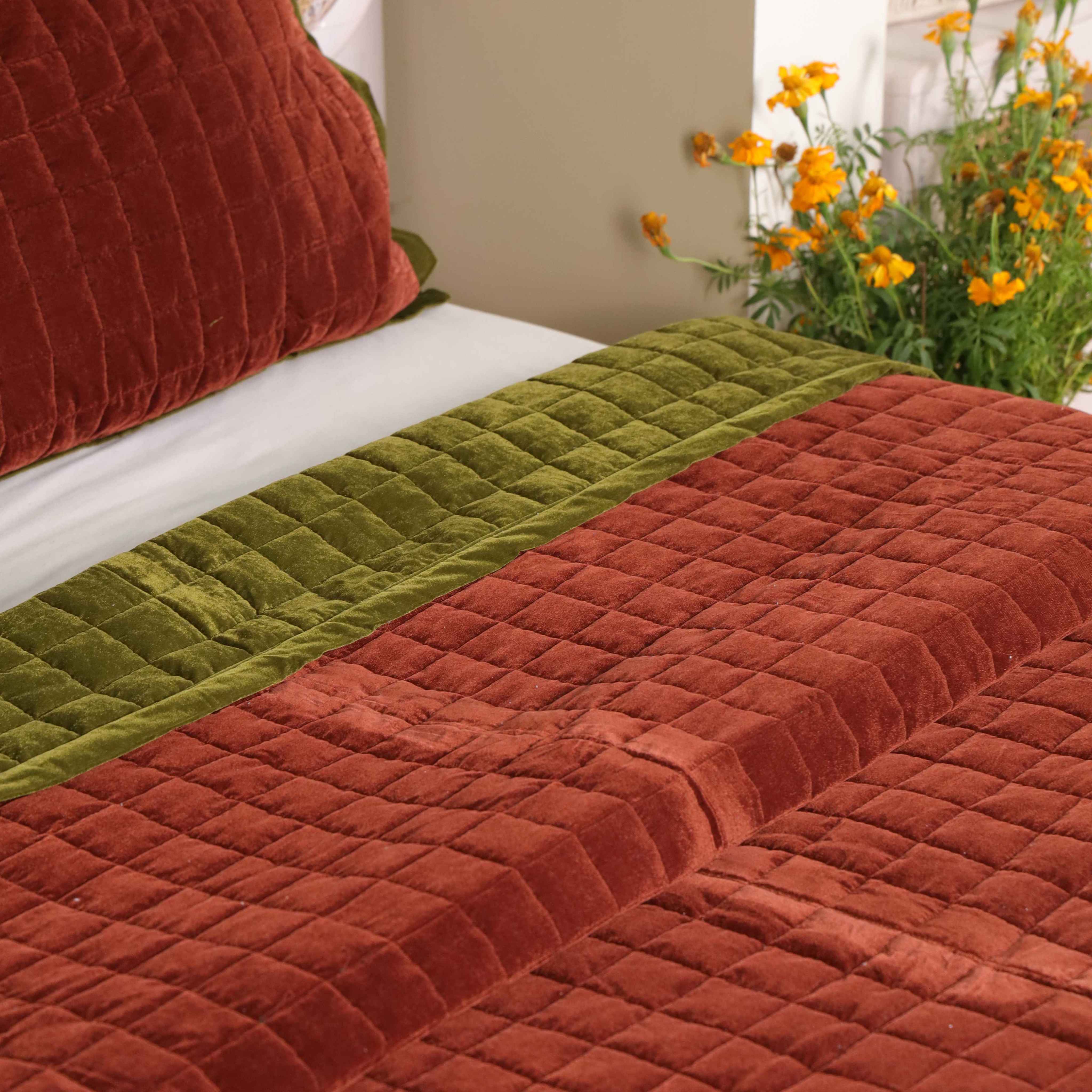 Two matching reversible velvet pillow covers showing both olive green and brick red colors.