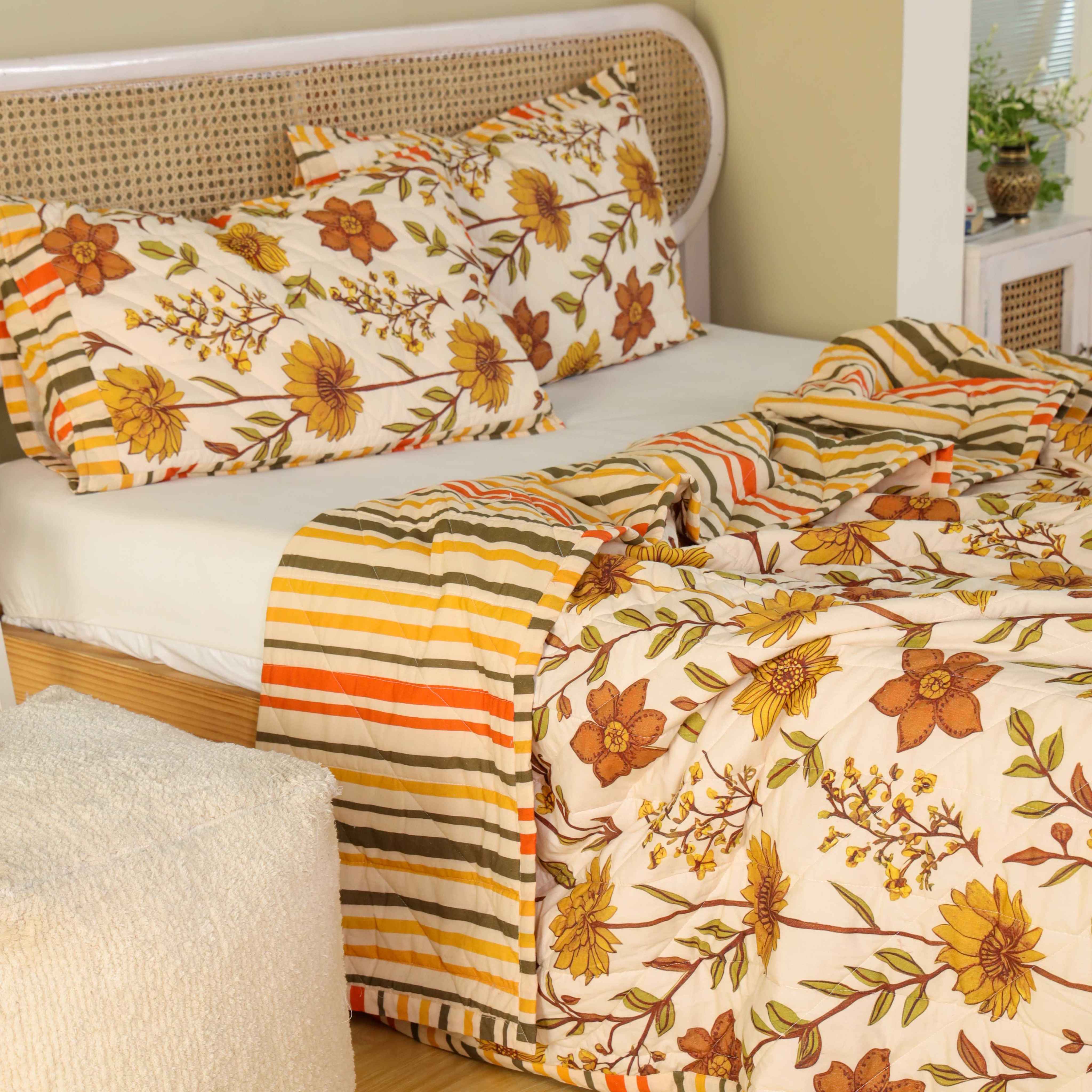 Two matching beige floral pillow covers with striped edge detailing.