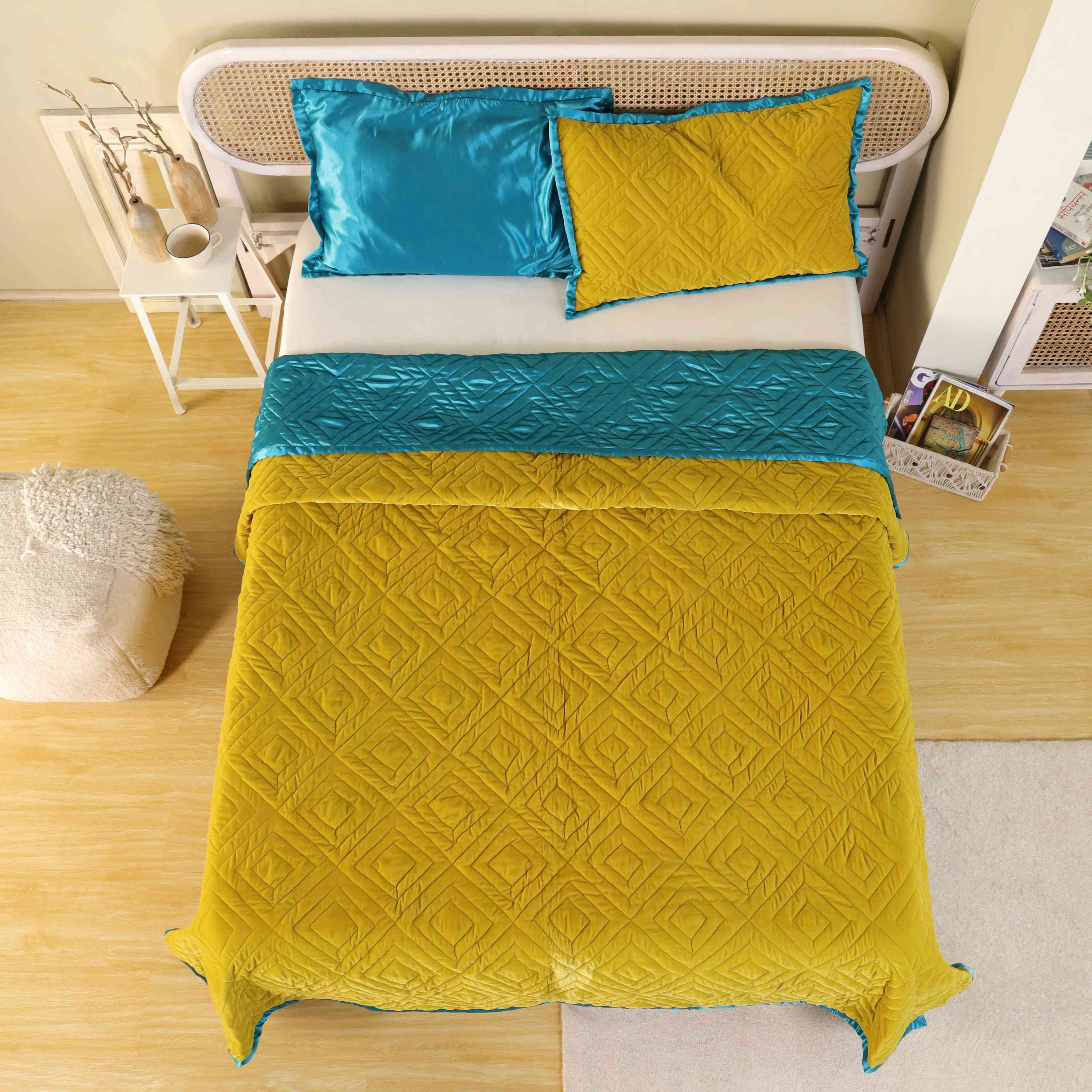 The teal blue satin reverse side of the mustard yellow velvet quilt.